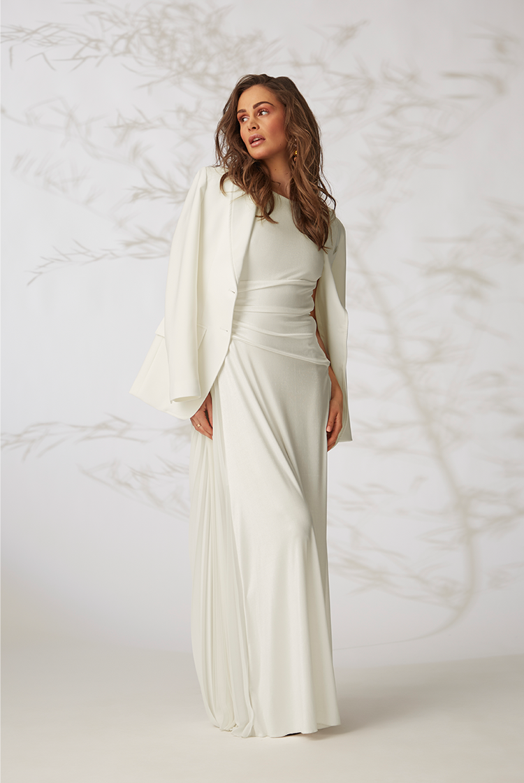 Frau in weißem Kleid und weißem Blazer